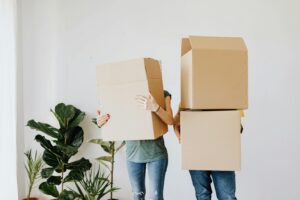 Couple Moving Boxes into New Home