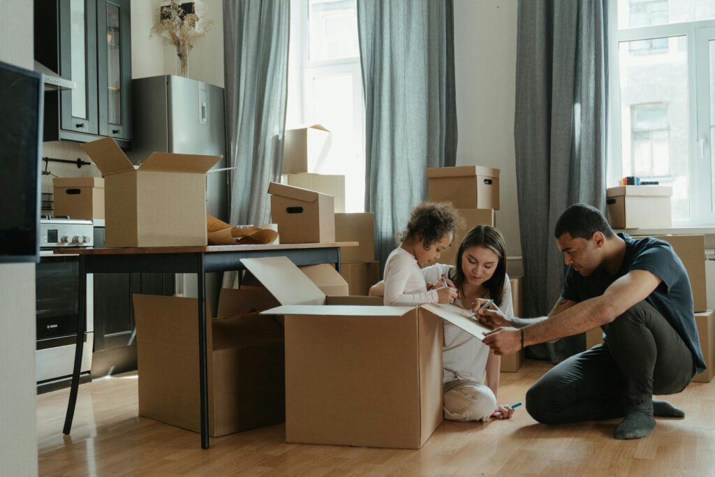 Family in new home surrounded by boxes.