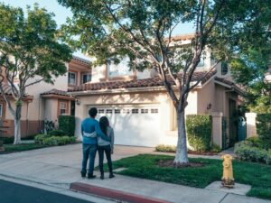 couple standing in front of home